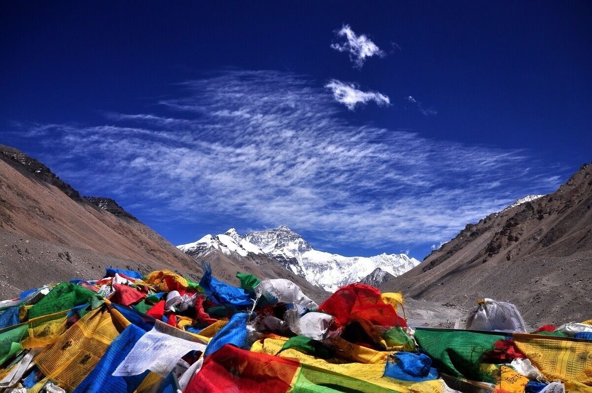 A mountain range with snow-capped peaks under a clear blue sky.