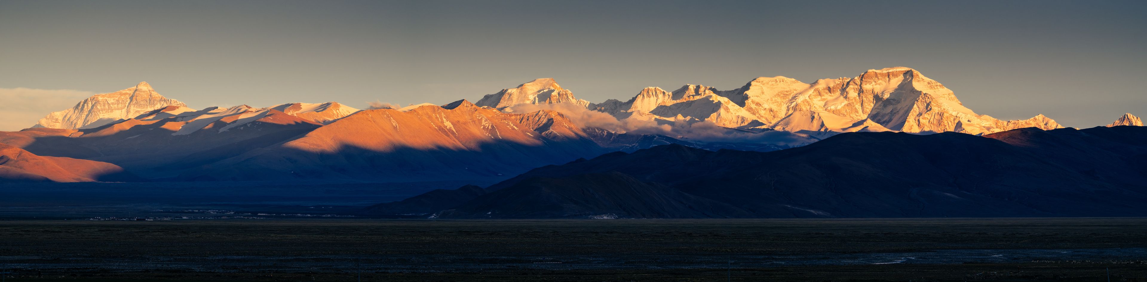 Sunset casts a warm golden glow over Mount Everest and Cho Oyu.