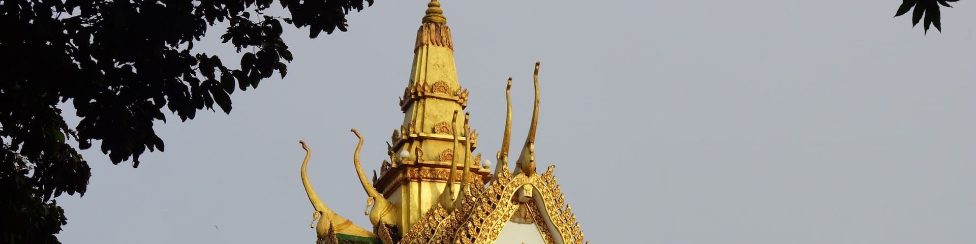 A temple with ornate golden decorations and a pointed roof.