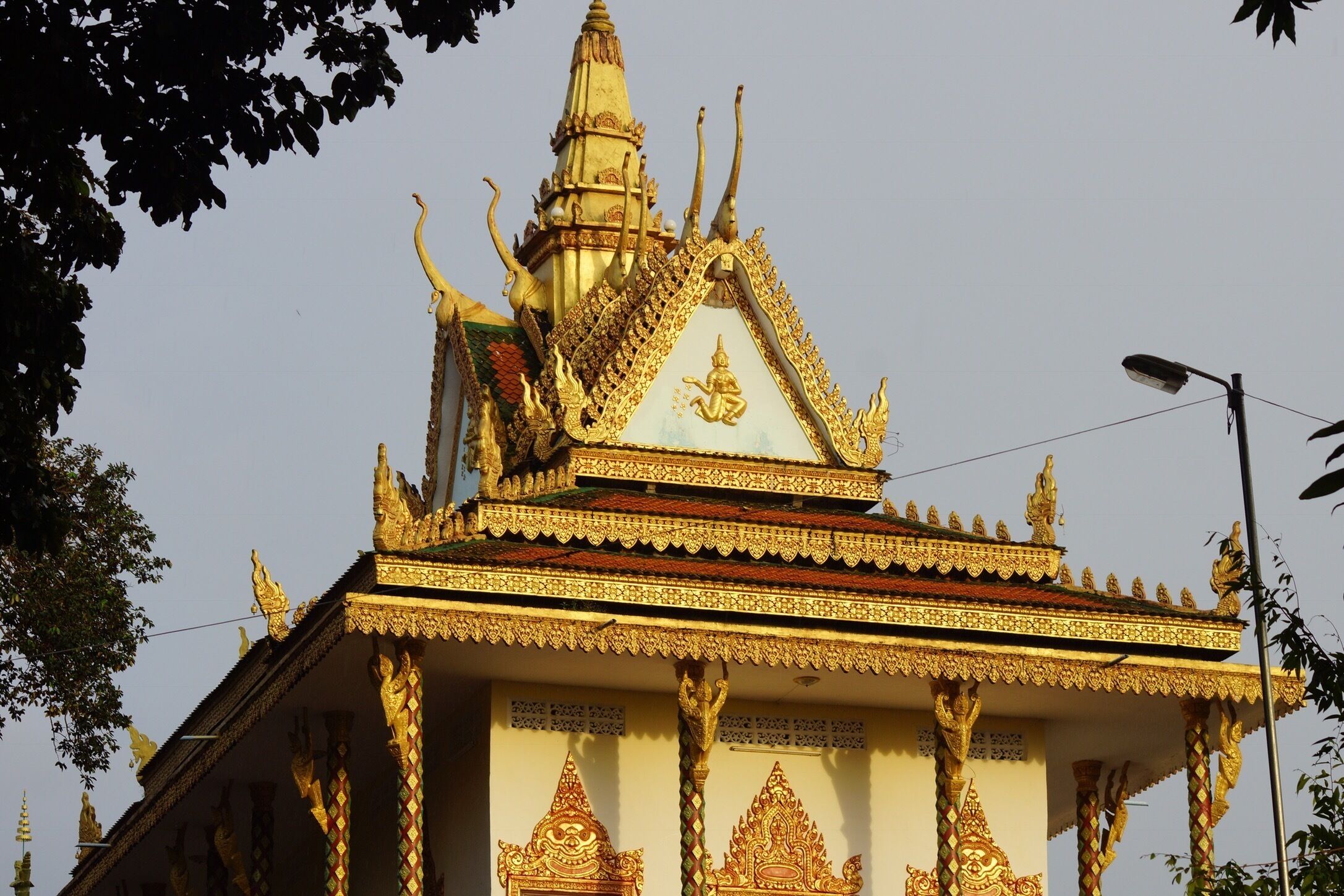 A temple with ornate golden decorations and a pointed roof.