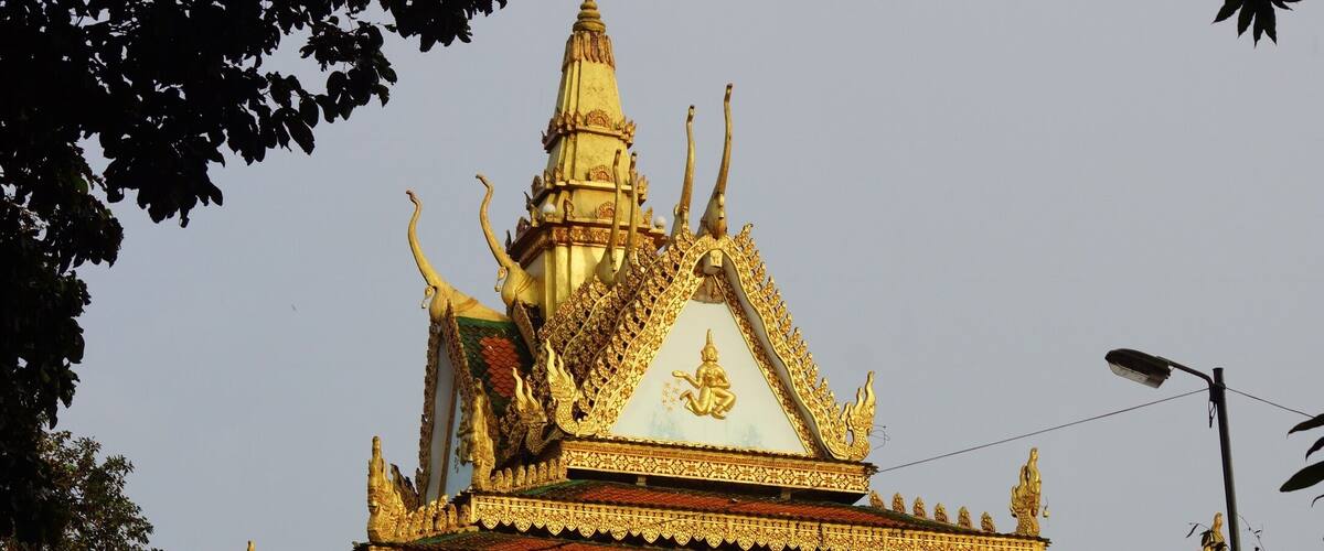 A temple with ornate golden decorations and a pointed roof.