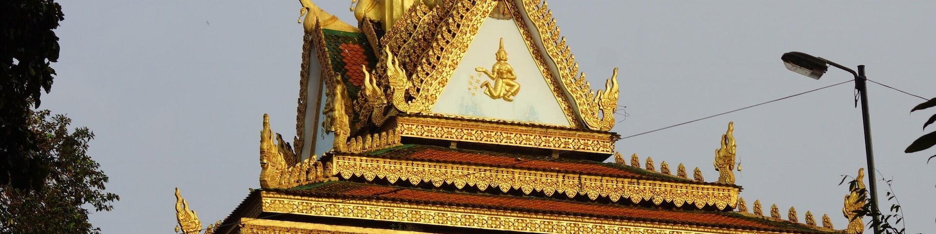 A temple with ornate golden decorations and a pointed roof.