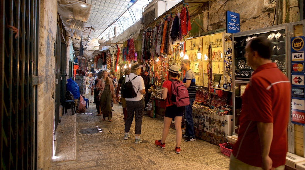 Mahane Yehuda Market which includes markets and street scenes as well as a small group of people