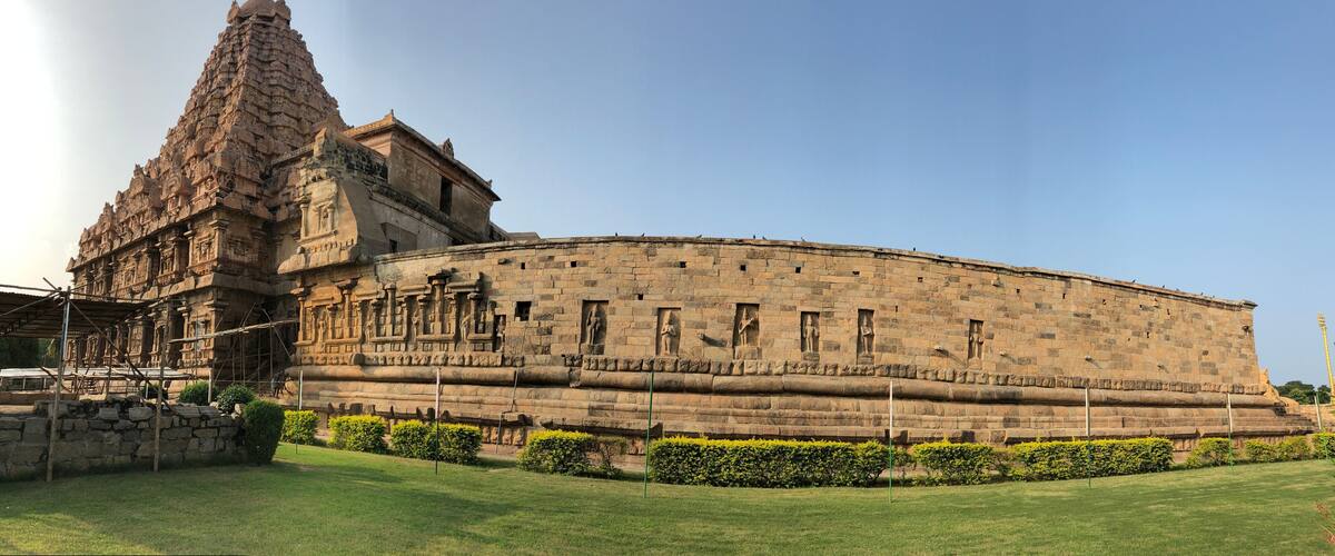 A large stone temple with intricate carvings and a tall spire.