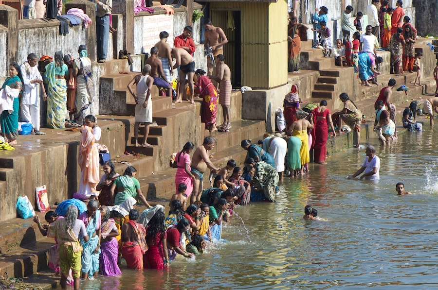 Unidentified people take a holy dip while celebrating Maha Shivaratri, a major Hindu festival on February 20, 2012 in Koti Theertha tank, Gokarna, Karnataka state, India.Gokarna is a popular destinati