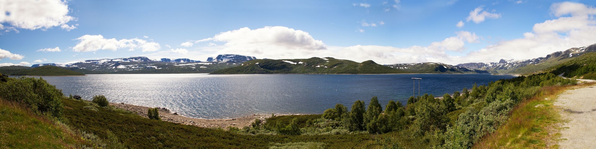 A lake surrounded by mountains and dense forest.