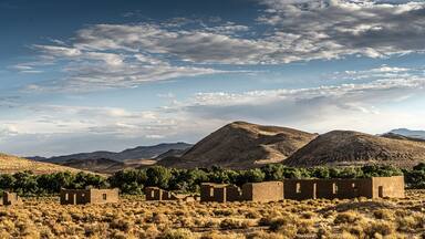 A desert landscape with mountains and a clear sky.