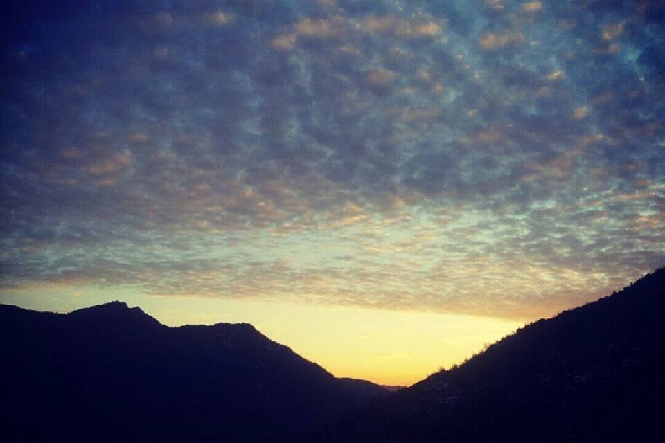A mountain range with a sunset sky.