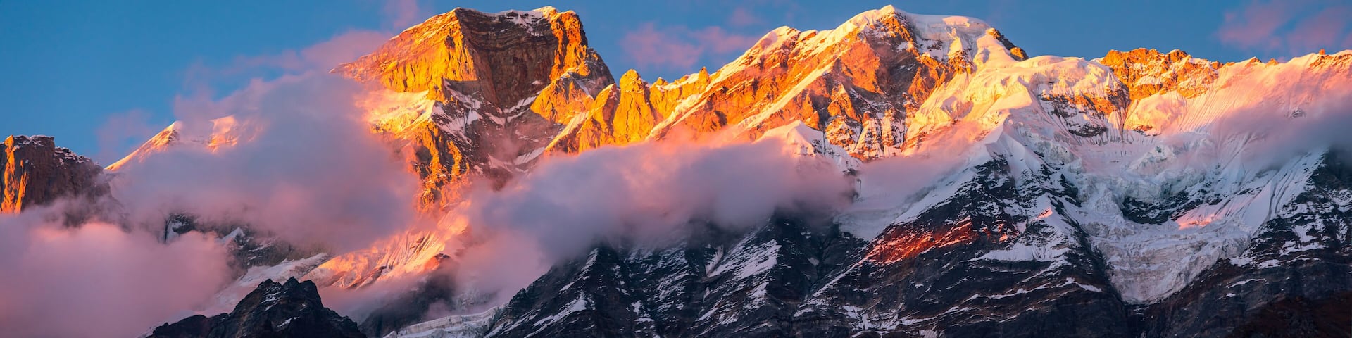 Panoramic view during sunset over snow cladded Kedarnath mountain peaks falls in Gangotri Himalayan mountain range from Kedarnath temple, Rudraprayag, Uttarakhand, India.