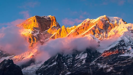 Panoramic view during sunset over snow cladded Kedarnath mountain peaks falls in Gangotri Himalayan mountain range from Kedarnath temple, Rudraprayag, Uttarakhand, India.