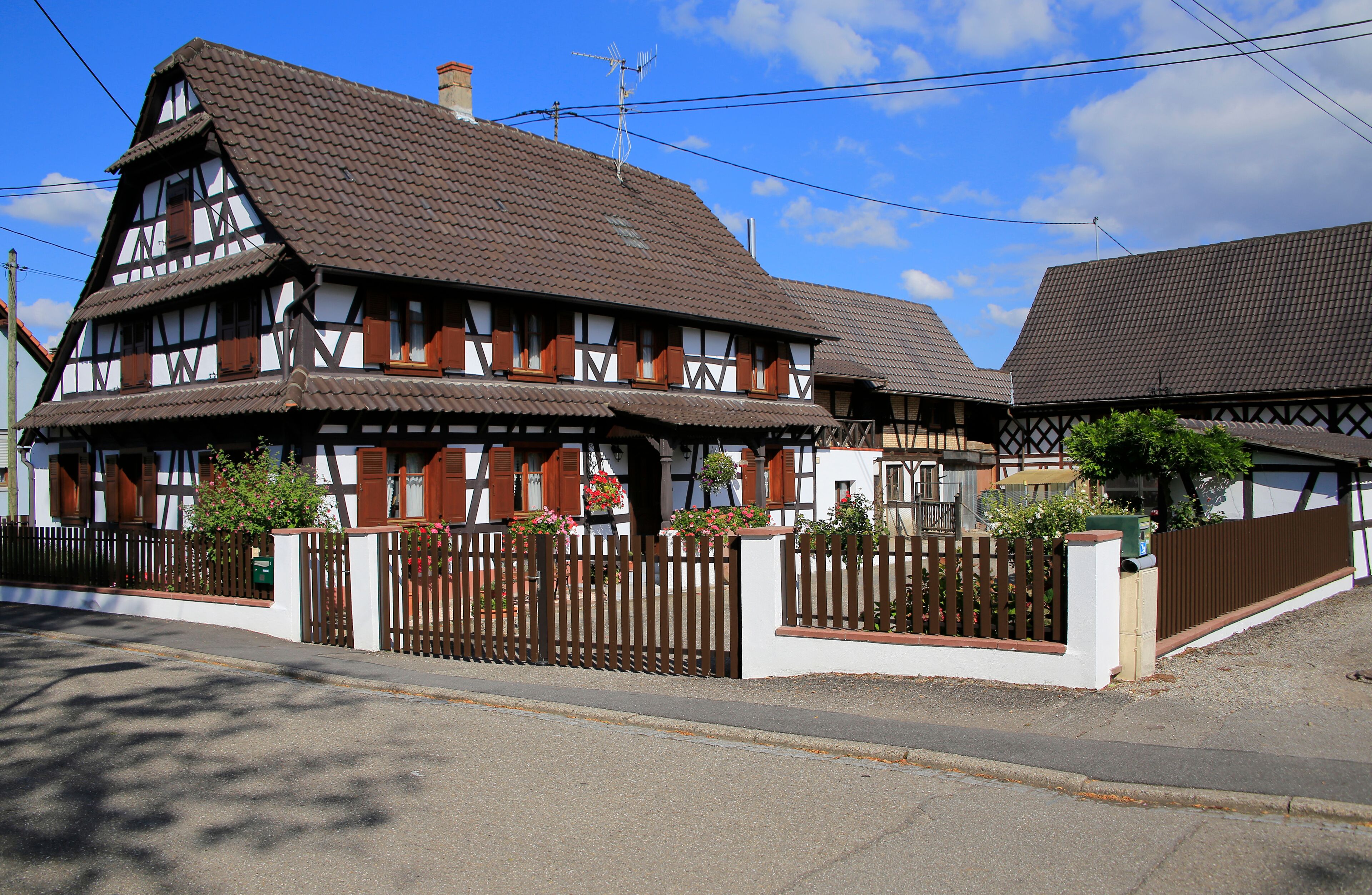A traditional half-timbered house with a sloped roof and wooden shutters.