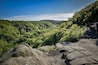 Great view over the green and lush forest valley of Soderasens National Park from cliff Sweden
