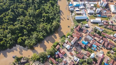 Residential center on the edge of a river and forest in a rural area, on the edge of a cross-regional road, in East Kotawaringin Regency, Central Kalimantan, Indonesia, seen from an aerial view.