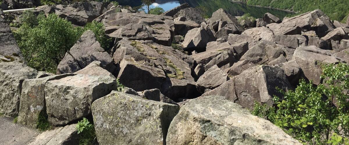 A rocky landscape with a valley and a lake.