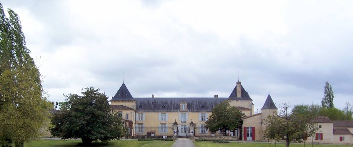 A large, historic building with multiple towers and a central entrance.