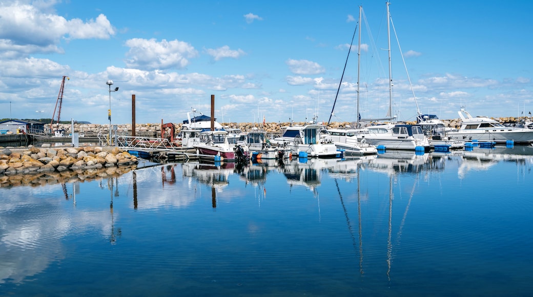 Simrishamn, Sweden - May 13, 2019: Boats at the marina on sunny day with reflectiom on water