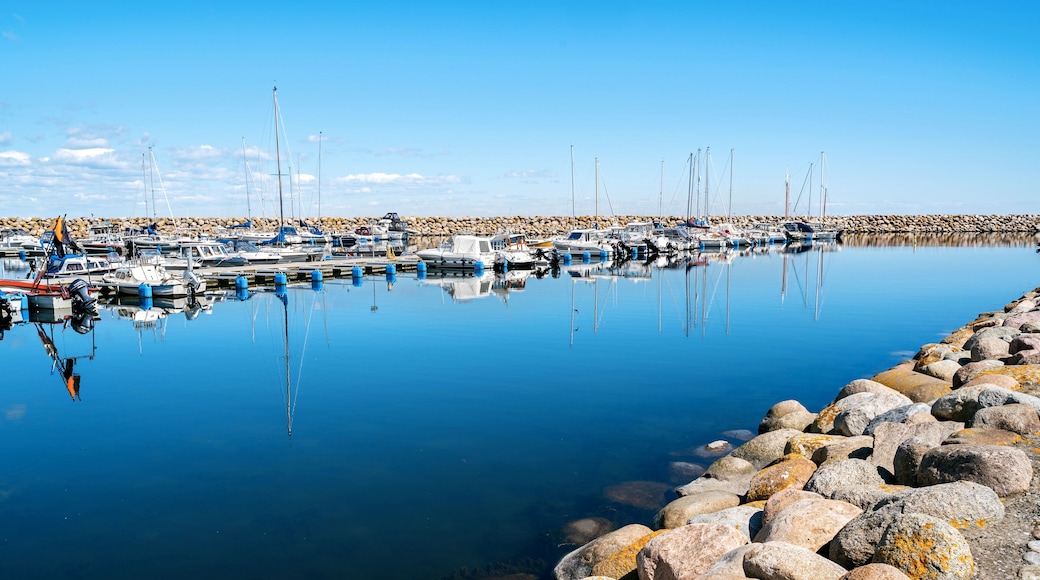 Simrishamn, Sweden - May 13, 2019: Boats at the marina on sunny day with reflectiom on water