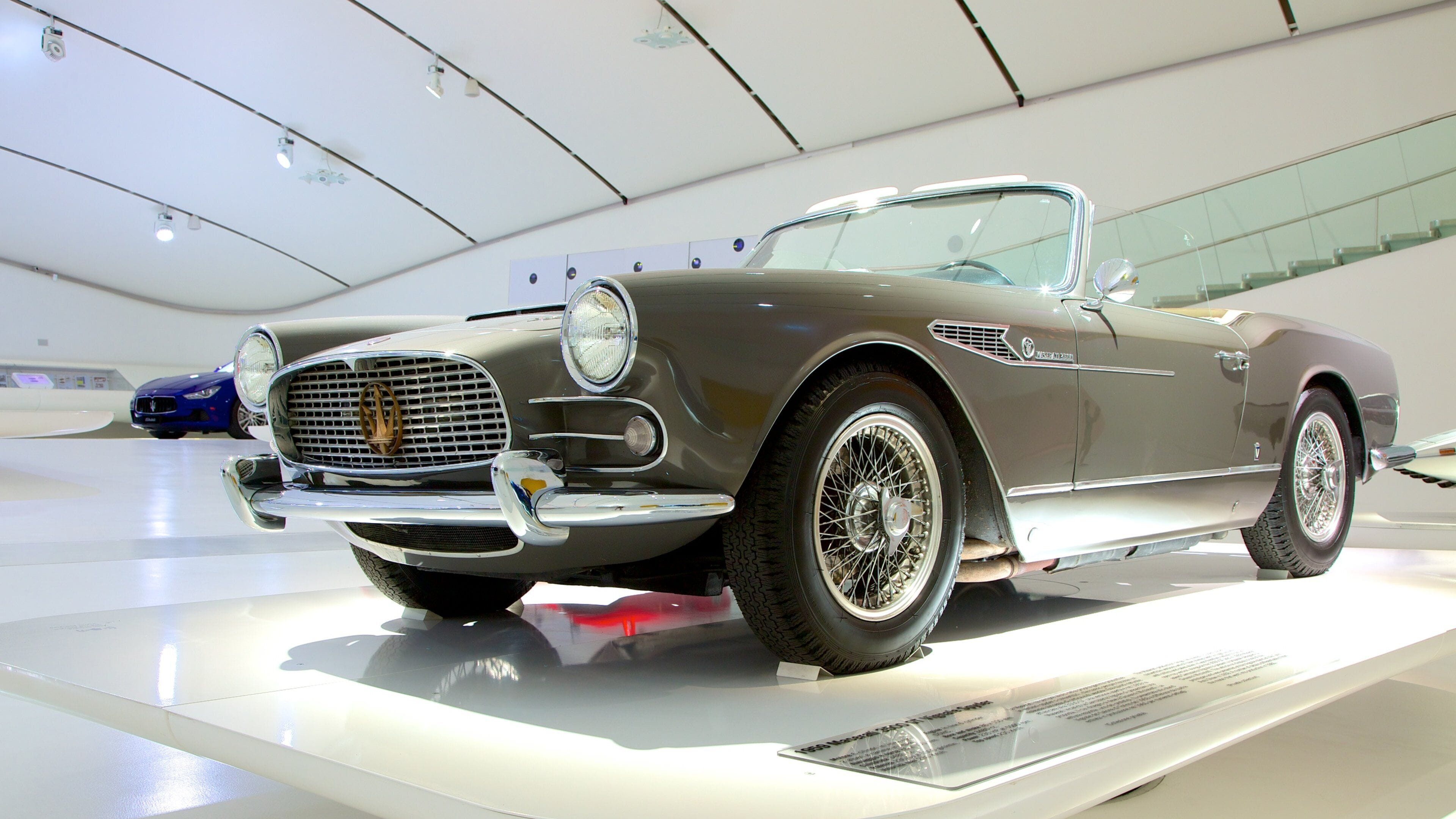 A classic convertible car on display in a museum.