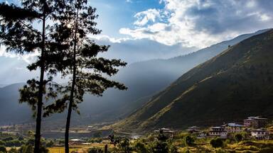 A mountainous landscape with a village nestled at the base.