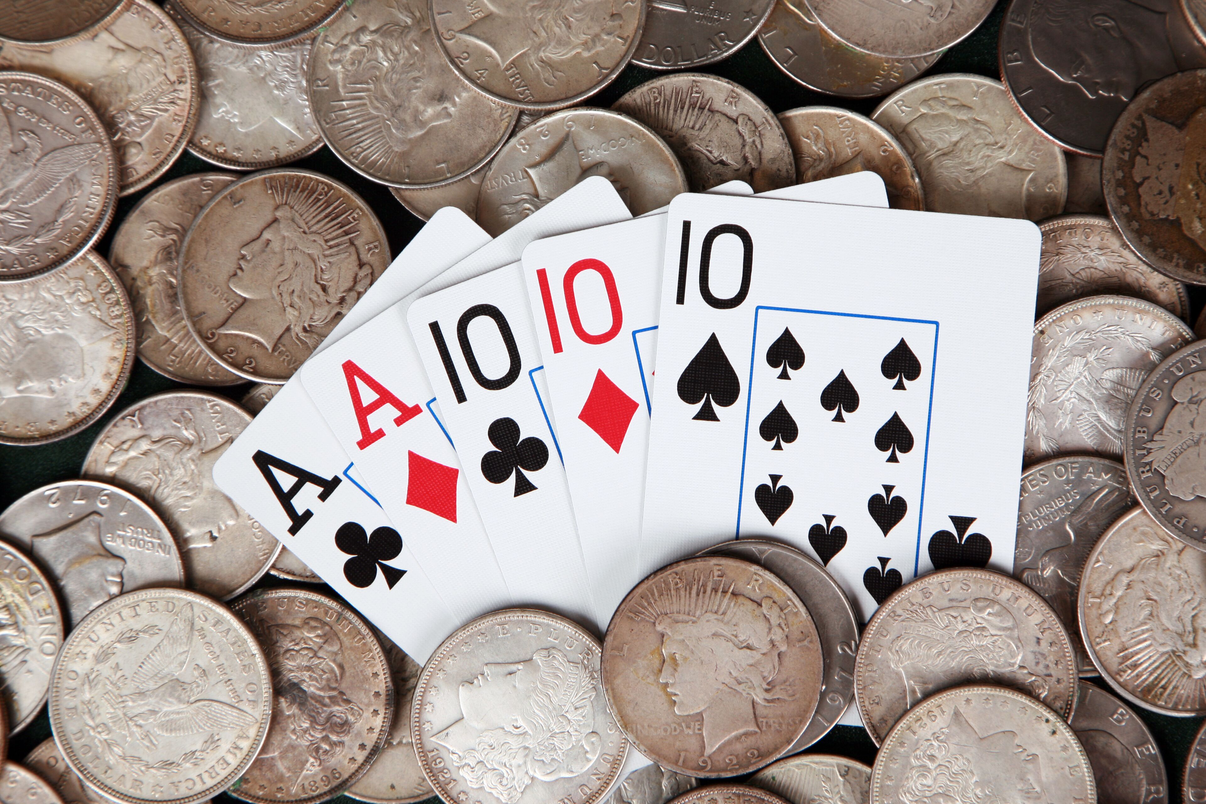 Full house and stacks of silver dollars