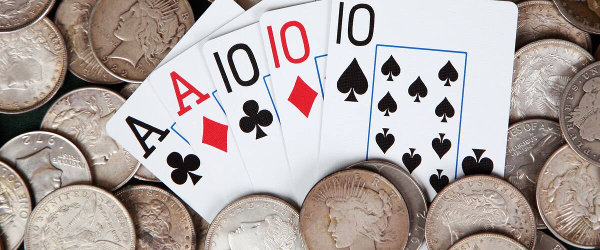 Full house and stacks of silver dollars