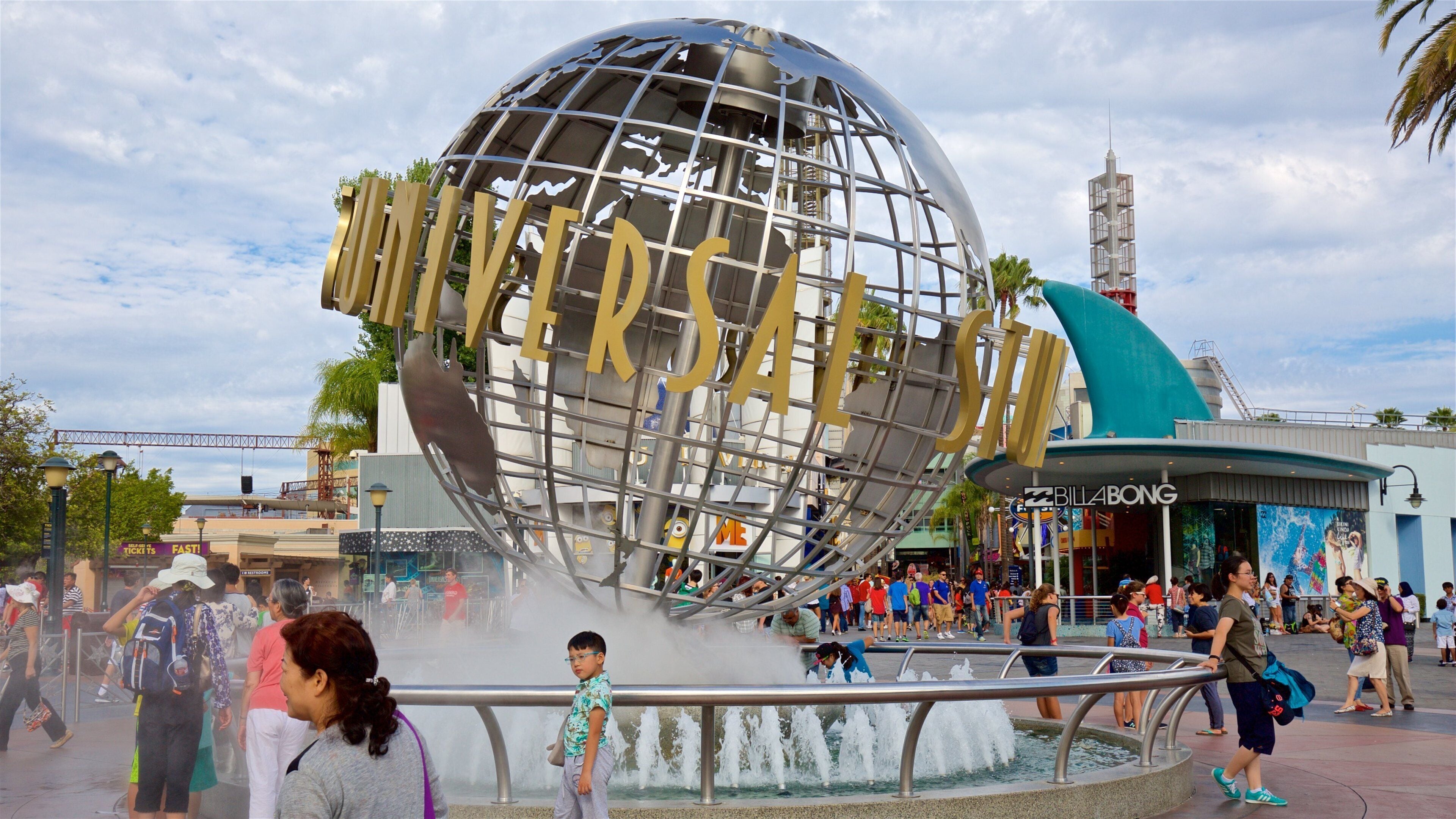 Universal CityWalk showing rides, signage and a fountain