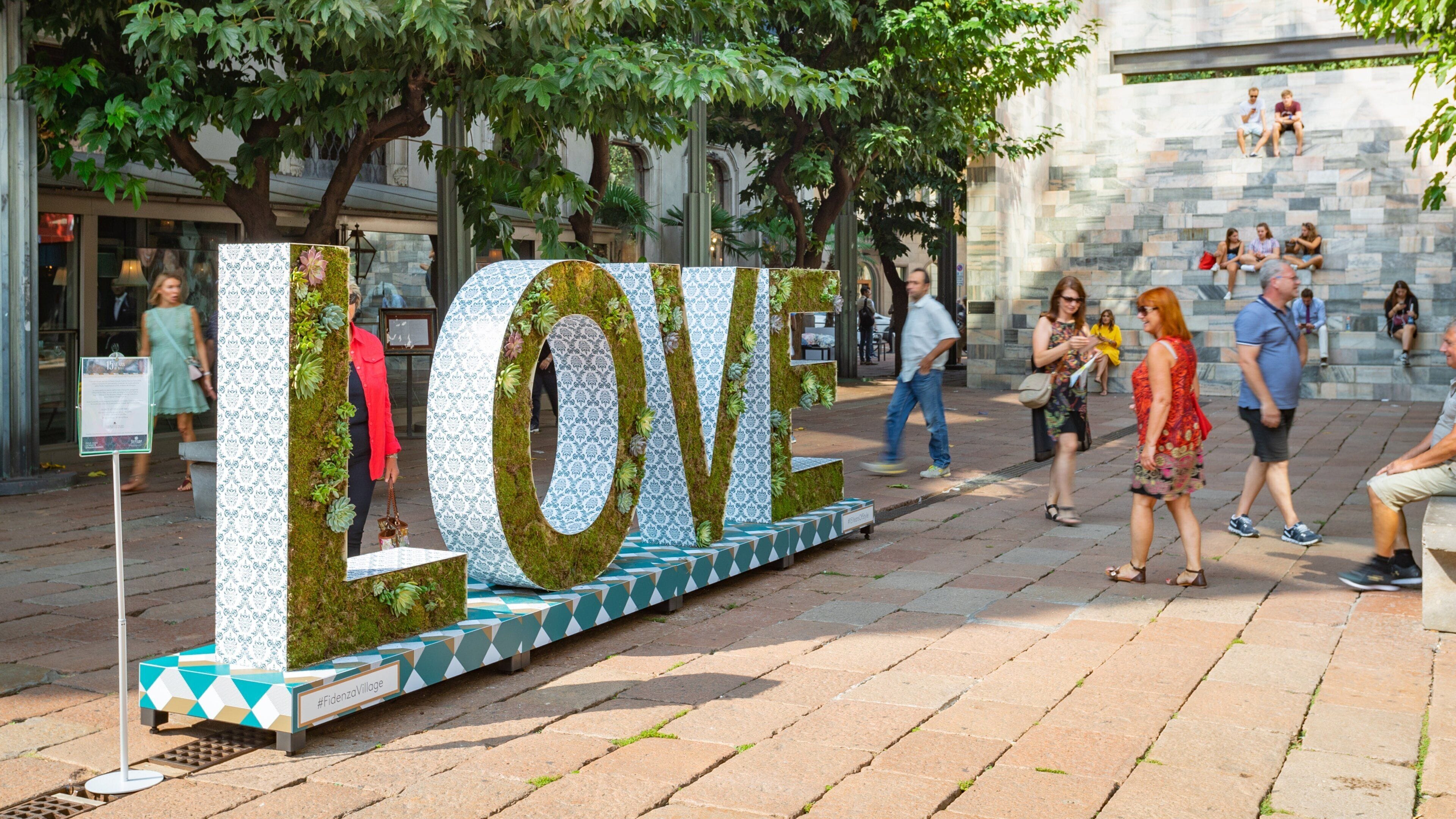 Armani Megastore which includes signage and outdoor art as well as a small group of people