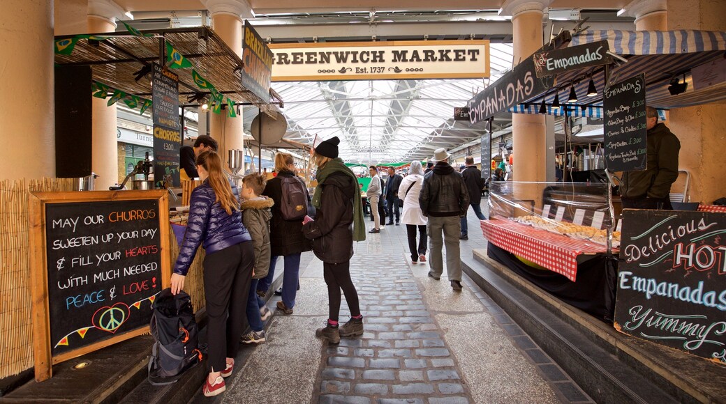 Greenwich Market showing markets and signage as well as a small group of people