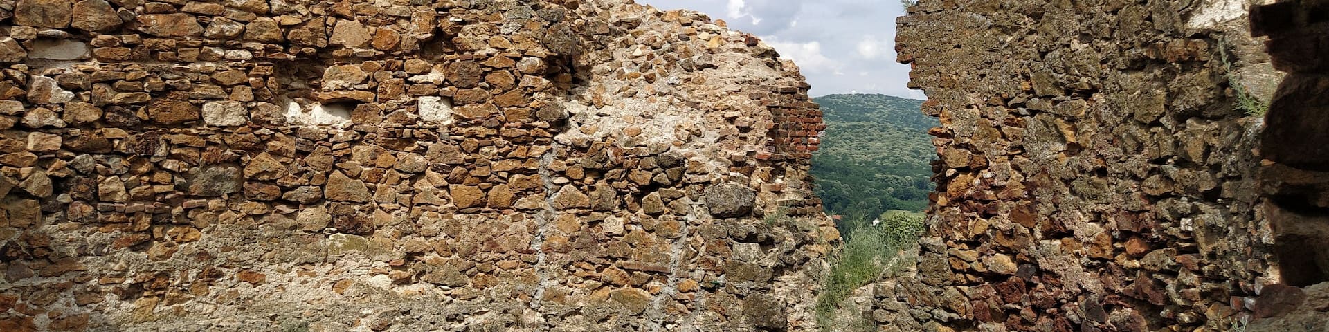Ruins of an old fortress in Vrdnik, Sremska Mitrovica, Vojvodina, Serbia. Ancient stone walls with mountain ranges in the background. Tourist historical landmarks