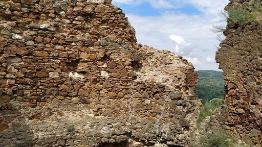 Ruins of an old fortress in Vrdnik, Sremska Mitrovica, Vojvodina, Serbia. Ancient stone walls with mountain ranges in the background. Tourist historical landmarks
