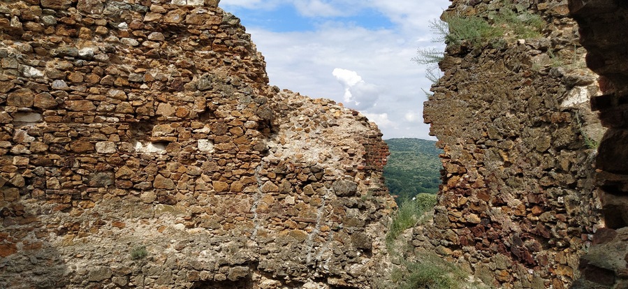 Ruins of an old fortress in Vrdnik, Sremska Mitrovica, Vojvodina, Serbia. Ancient stone walls with mountain ranges in the background. Tourist historical landmarks