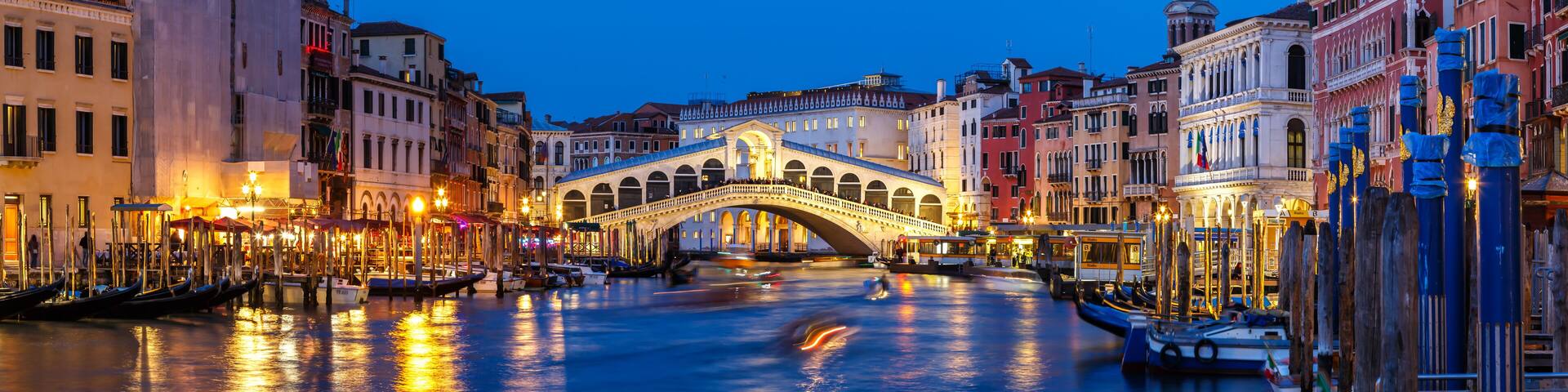 Venice Rialto bridge over Canal Grande with gondola travel traveling holidays vacation town panorama at night in Italy