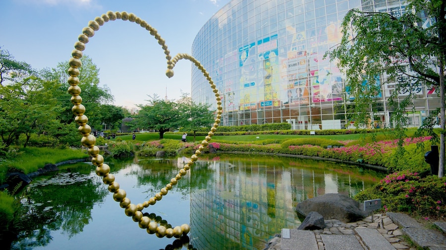 Roppongi Hills featuring outdoor art, modern architecture and a pond