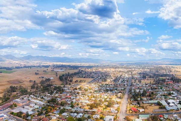 Une vue panoramique d’une ville nichée dans une vallée, avec des montagnes en arrière-plan.