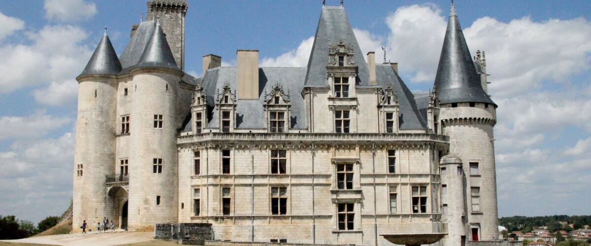 A historic castle with multiple towers and a large courtyard.