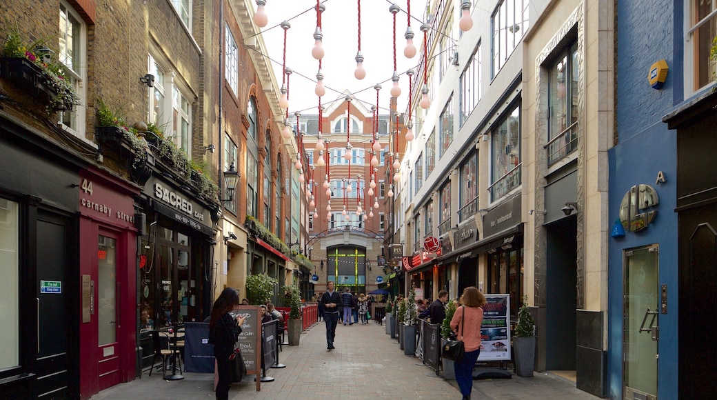Carnaby Street which includes heritage architecture and a square or plaza as well as a small group of people