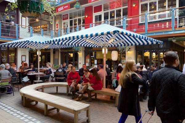 Carnaby Street featuring a square or plaza as well as a large group of people