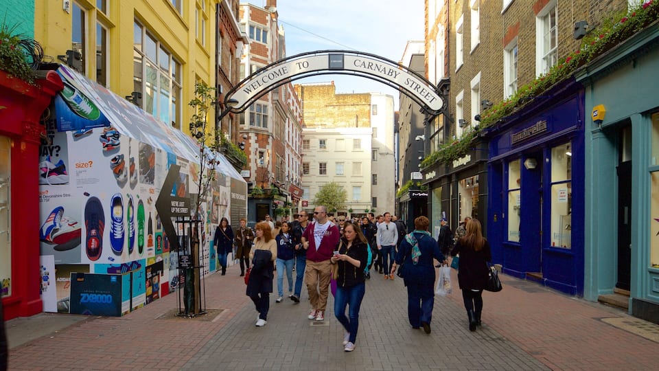 Carnaby Street featuring a square or plaza and heritage architecture as well as a large group of people