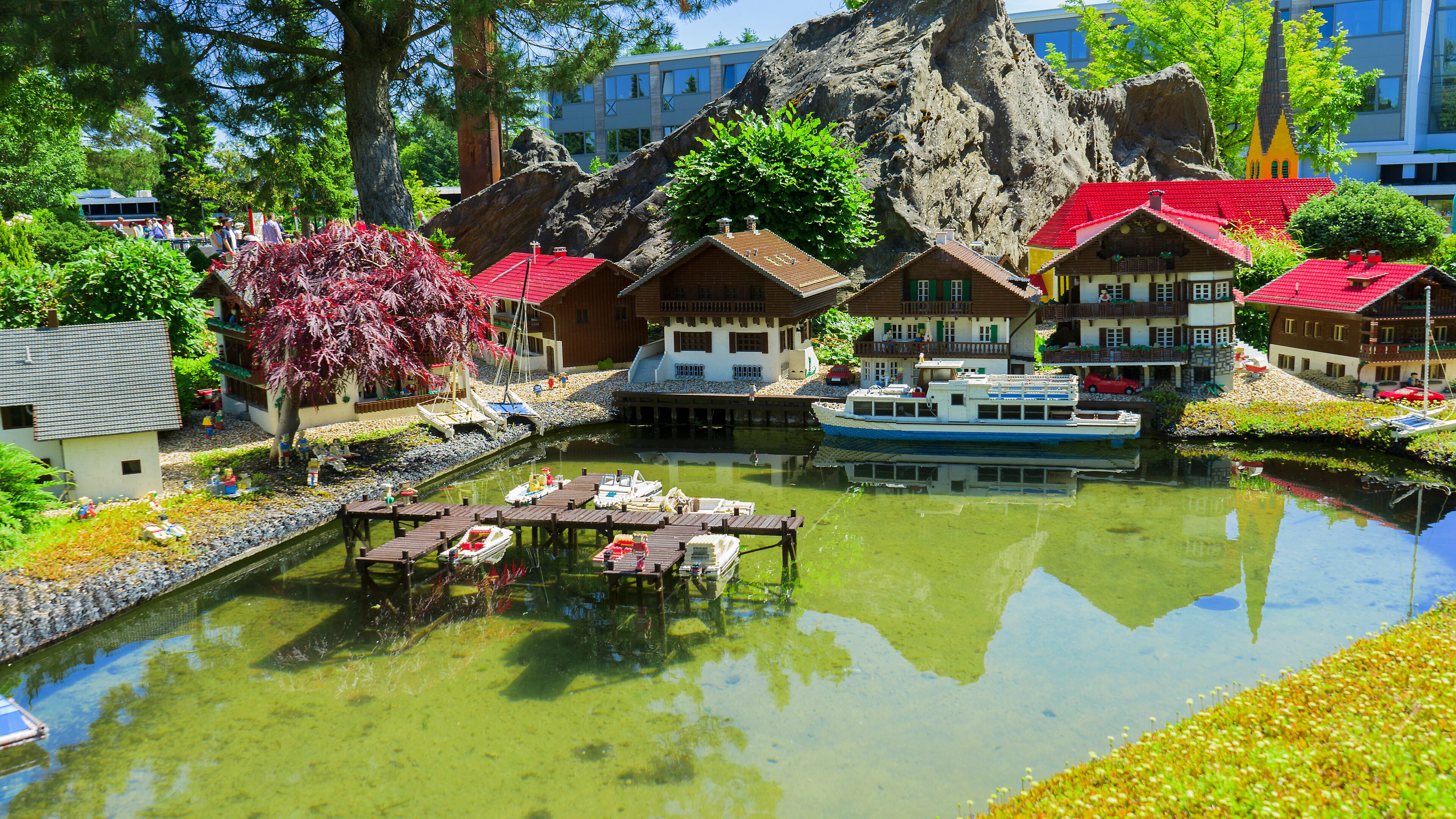 A model village with a river, boats, and colorful houses.