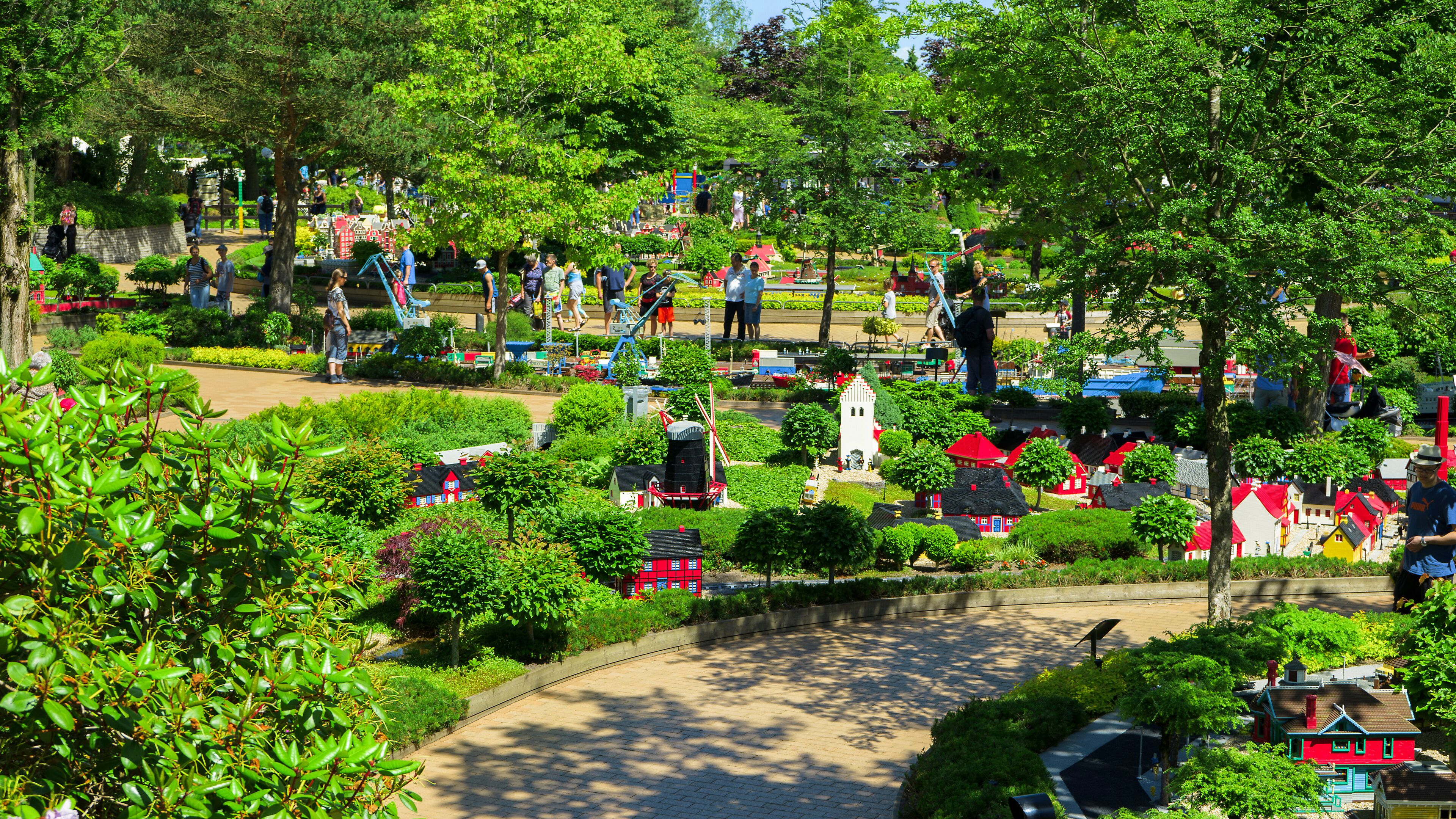 A model village with miniature houses and a winding path.