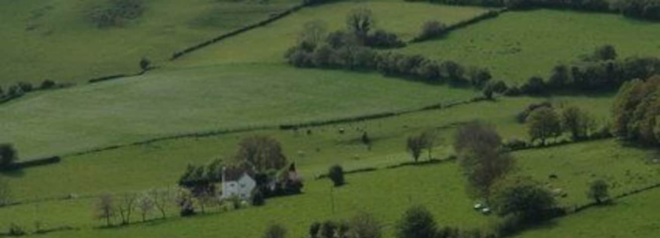 Kelston Round Hill from Lansdown Kelston Round Hill (sometimes known locally as Kelston Tump) forms a skyline landmark from all round the Avon valley between Bath and Bristol. Foxhall Farm nestles below.