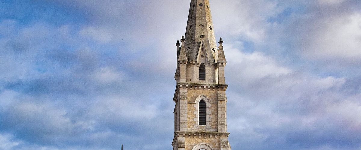 A historic church with a tall bell tower and a clock.