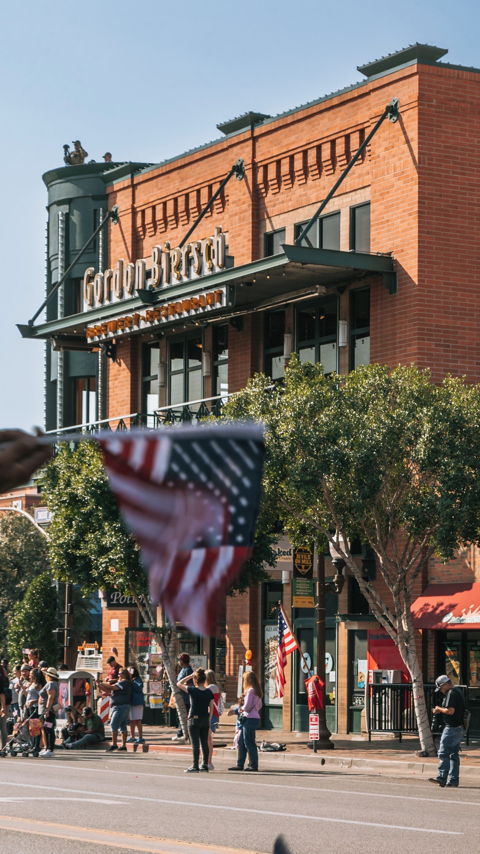 Celebrating community spirit in Mill Avenue District of Tempe, Arizona during an outdoor event with American flags on display