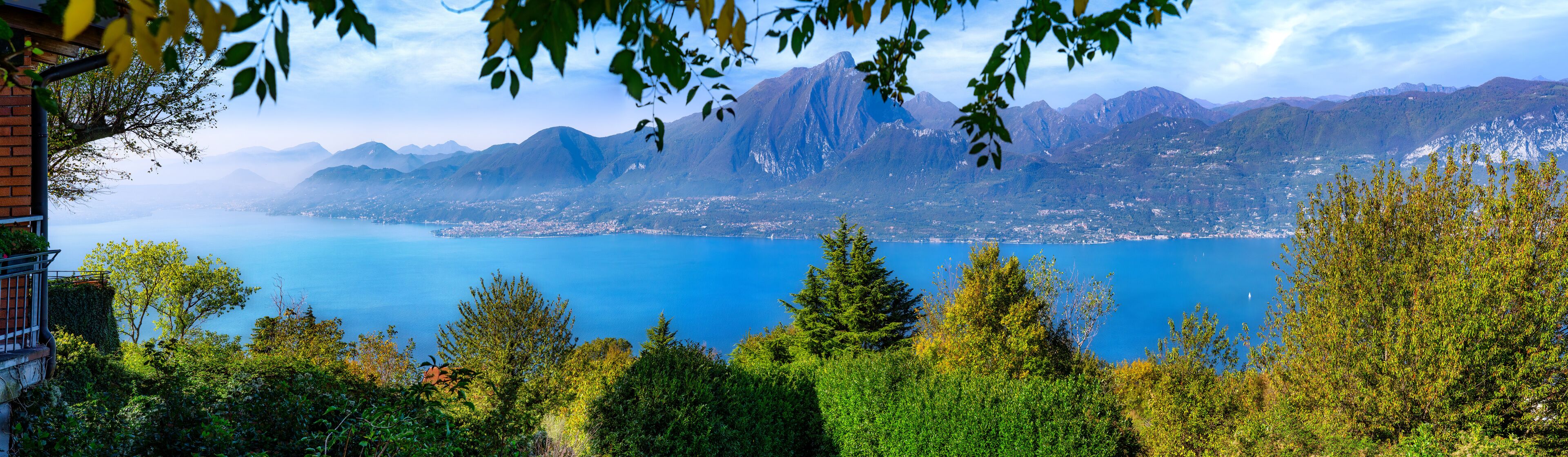 A mountainous landscape with a lake and a town in the valley.