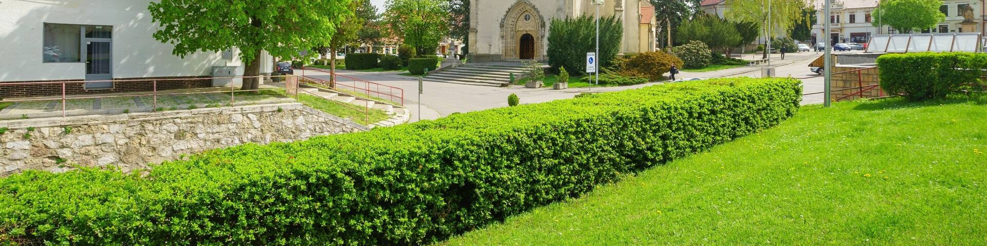 spring square and the church of St. Michael in Hlohovec, looking at the central entrance to the church