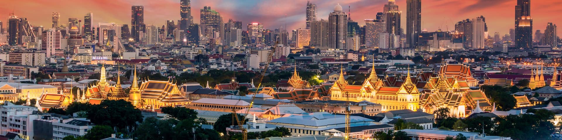 A cityscape with modern skyscrapers and traditional temple architecture.