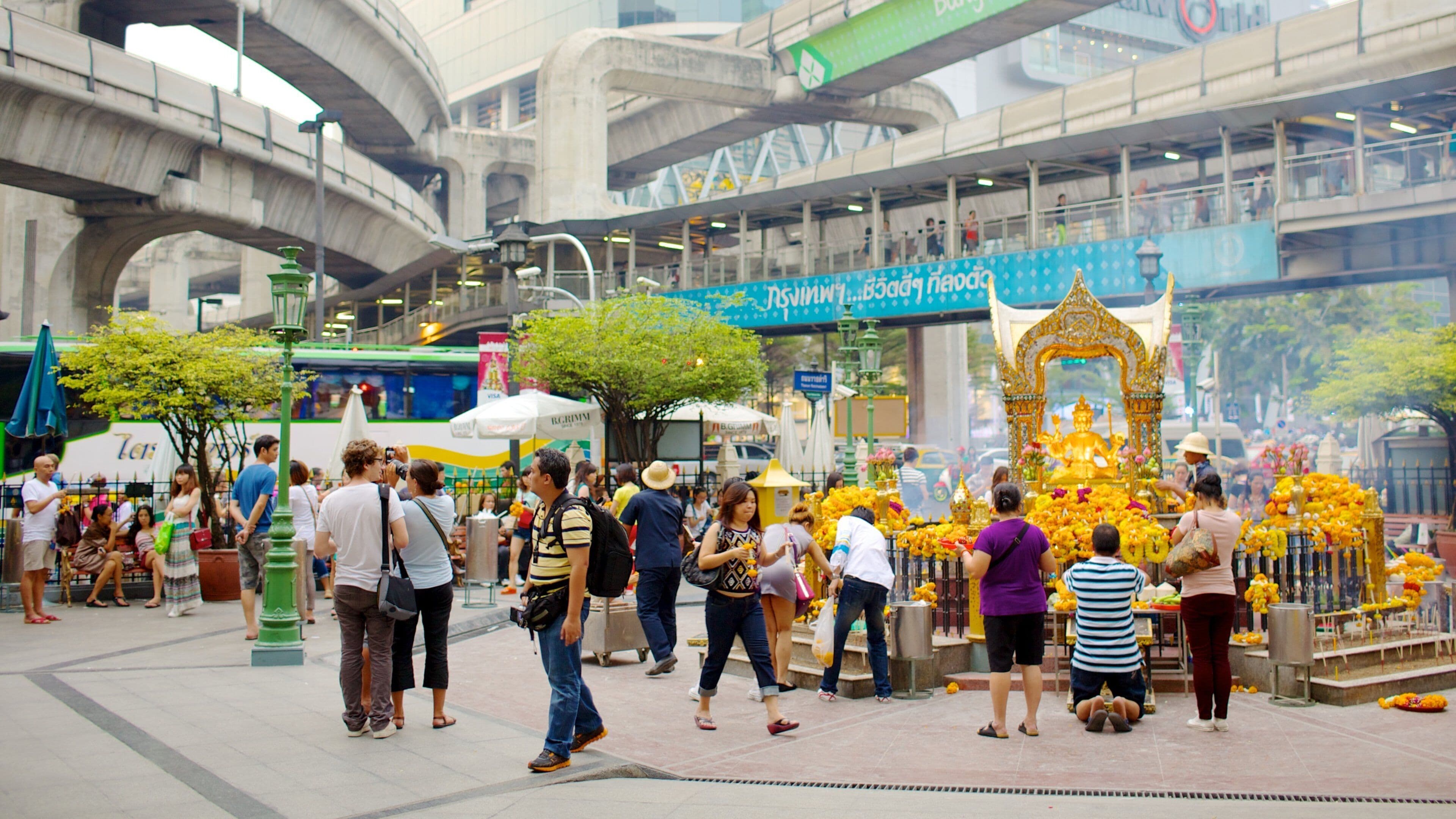 Bangkok City Centre showing religious elements and a square or plaza as well as a small group of people
