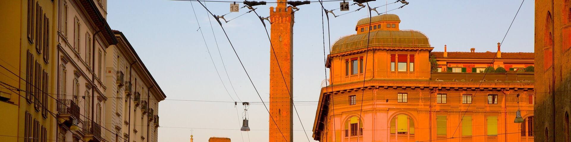 A bustling street with historic buildings, a prominent tower, and a tram.