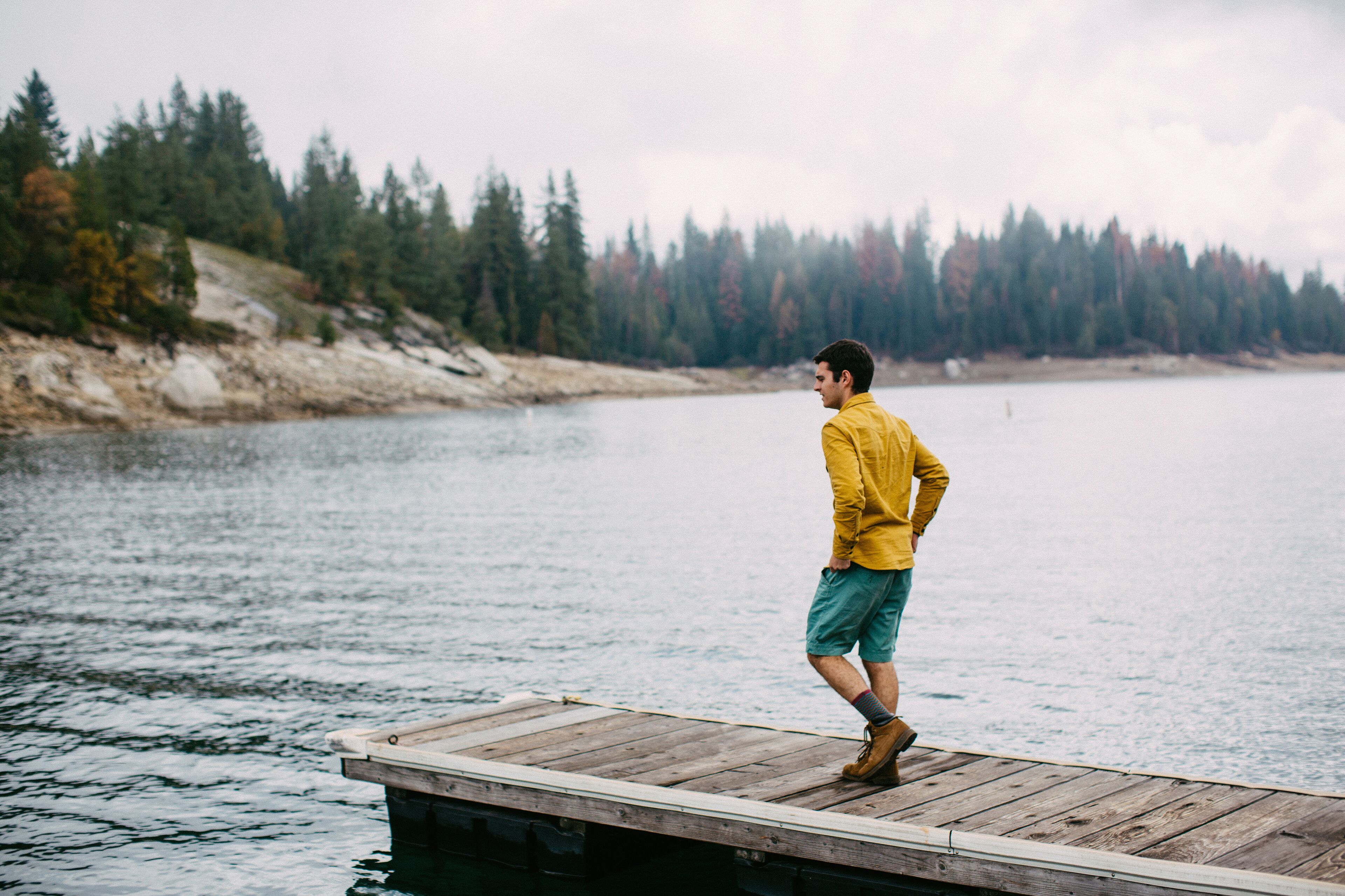 Young man walking on pier at Shaver Lake, California, USA