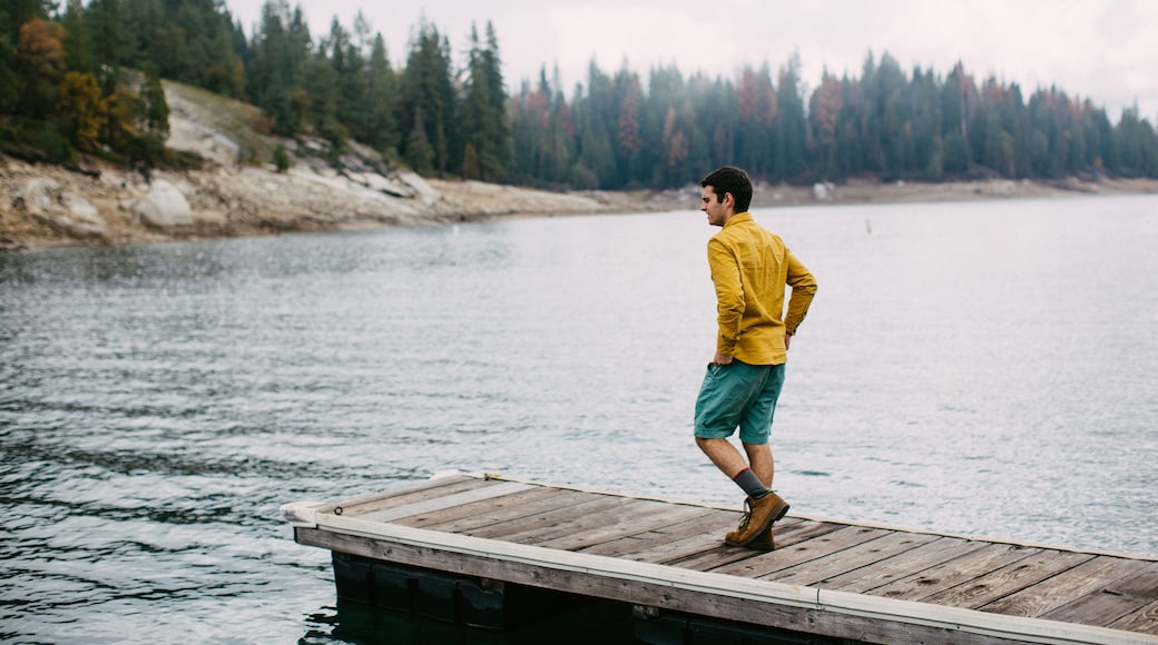 Young man walking on pier at Shaver Lake, California, USA